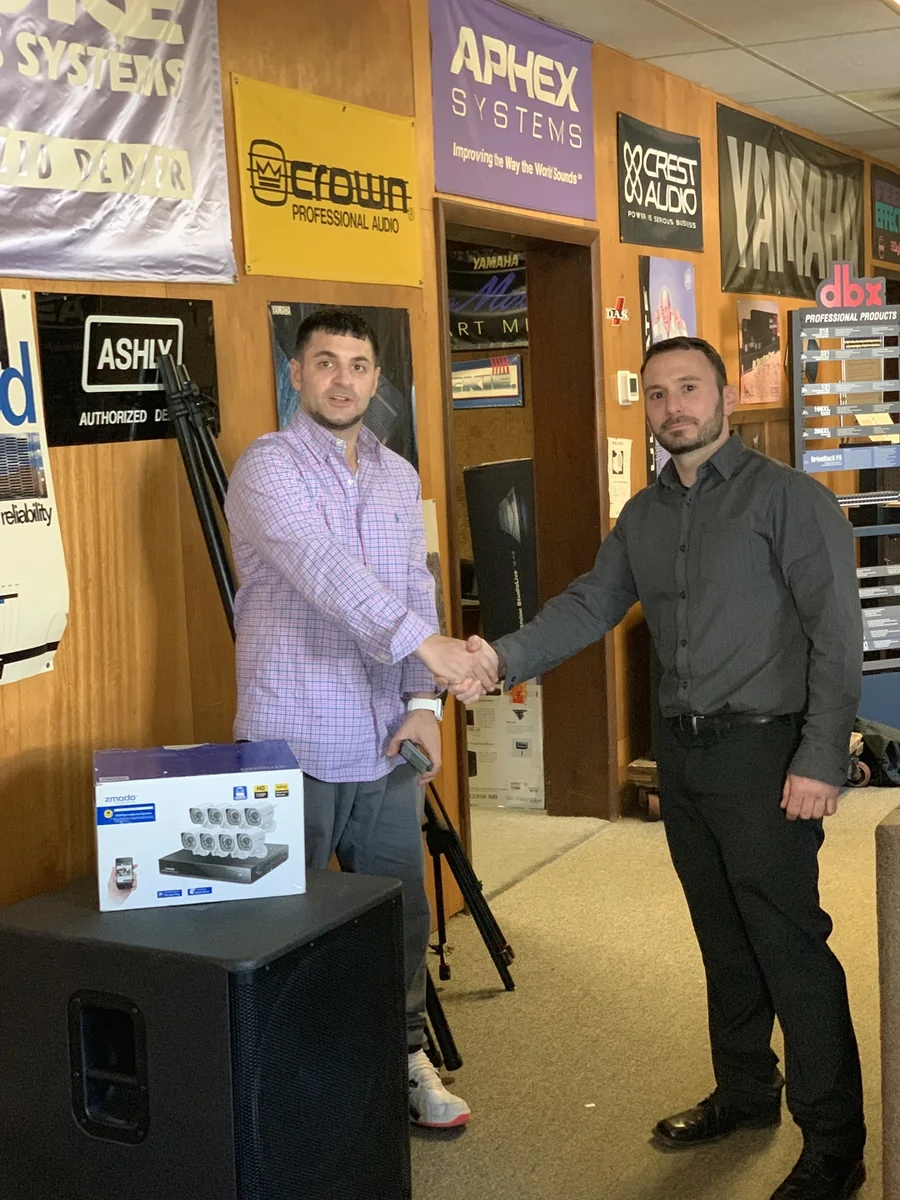 Michael P. Goodman shaking hands with a client after delivering a security camera system
